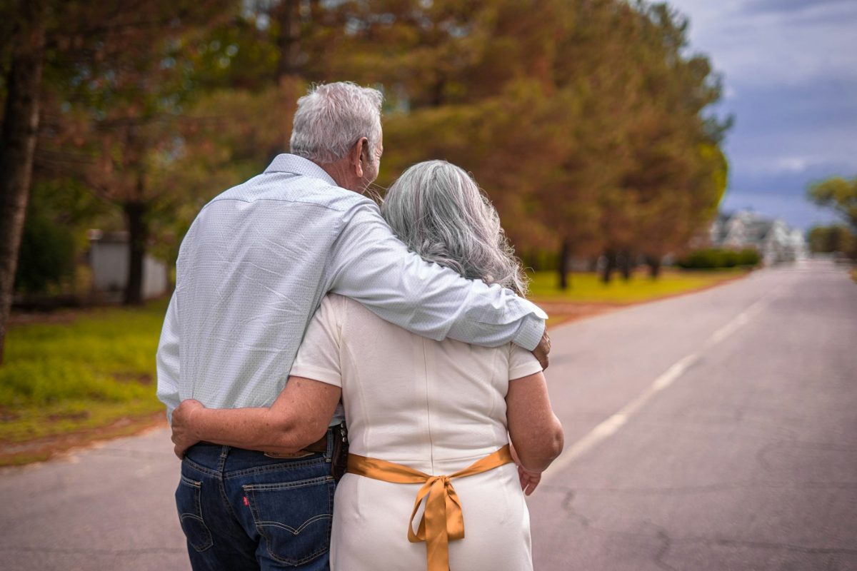 Older couple walking arm in arm